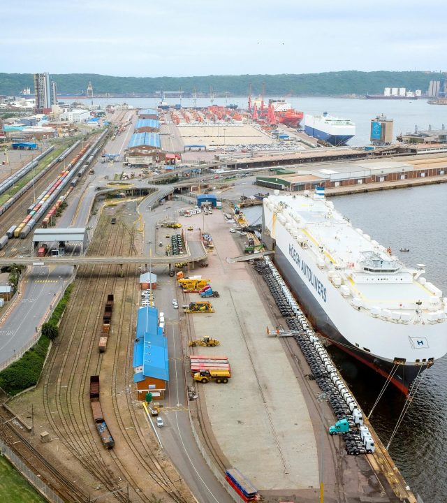 Aerial shot of Durban harbor capturing docked ship and surrounding infrastructure.
